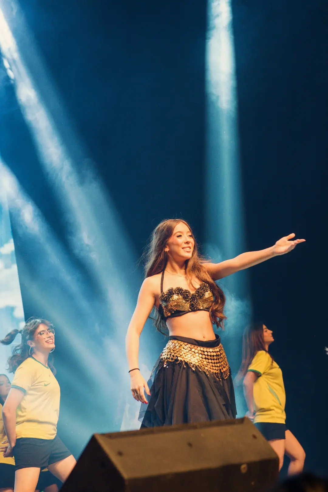 Bailarina de figurino cigano sob feixes de luz azul